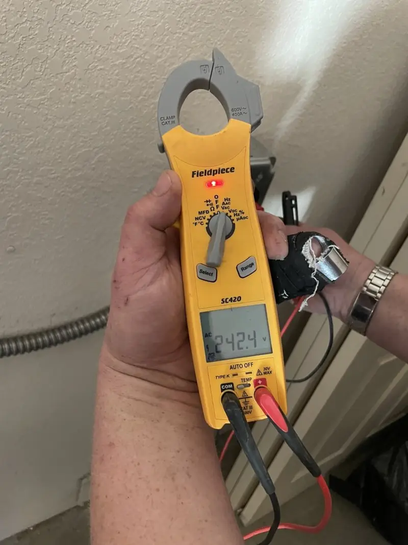 Voltage testing with clamp meter during Recessed Lighting Installation in Benton